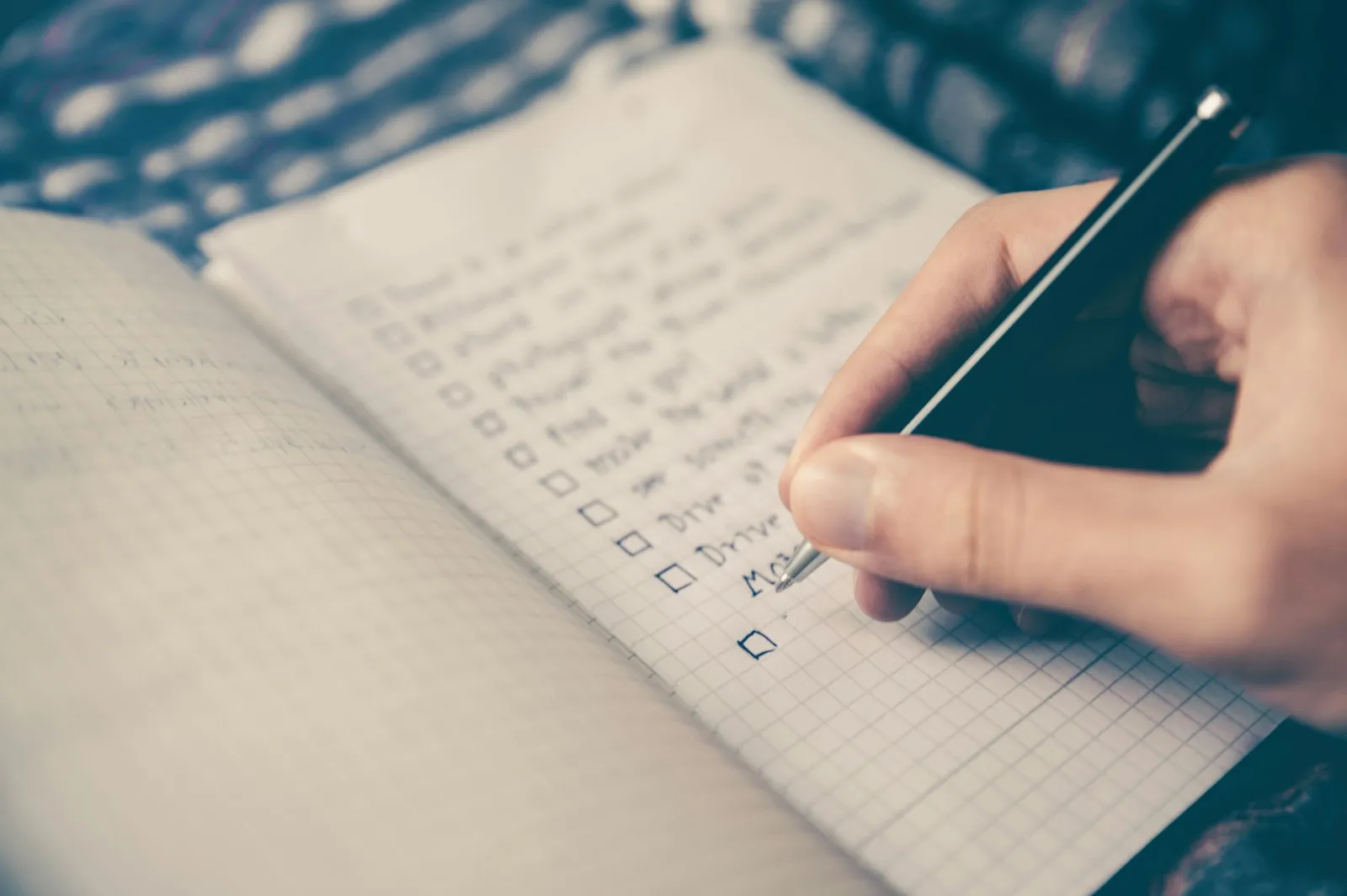 A notebook and planning materials laid out on an event organizer's desk