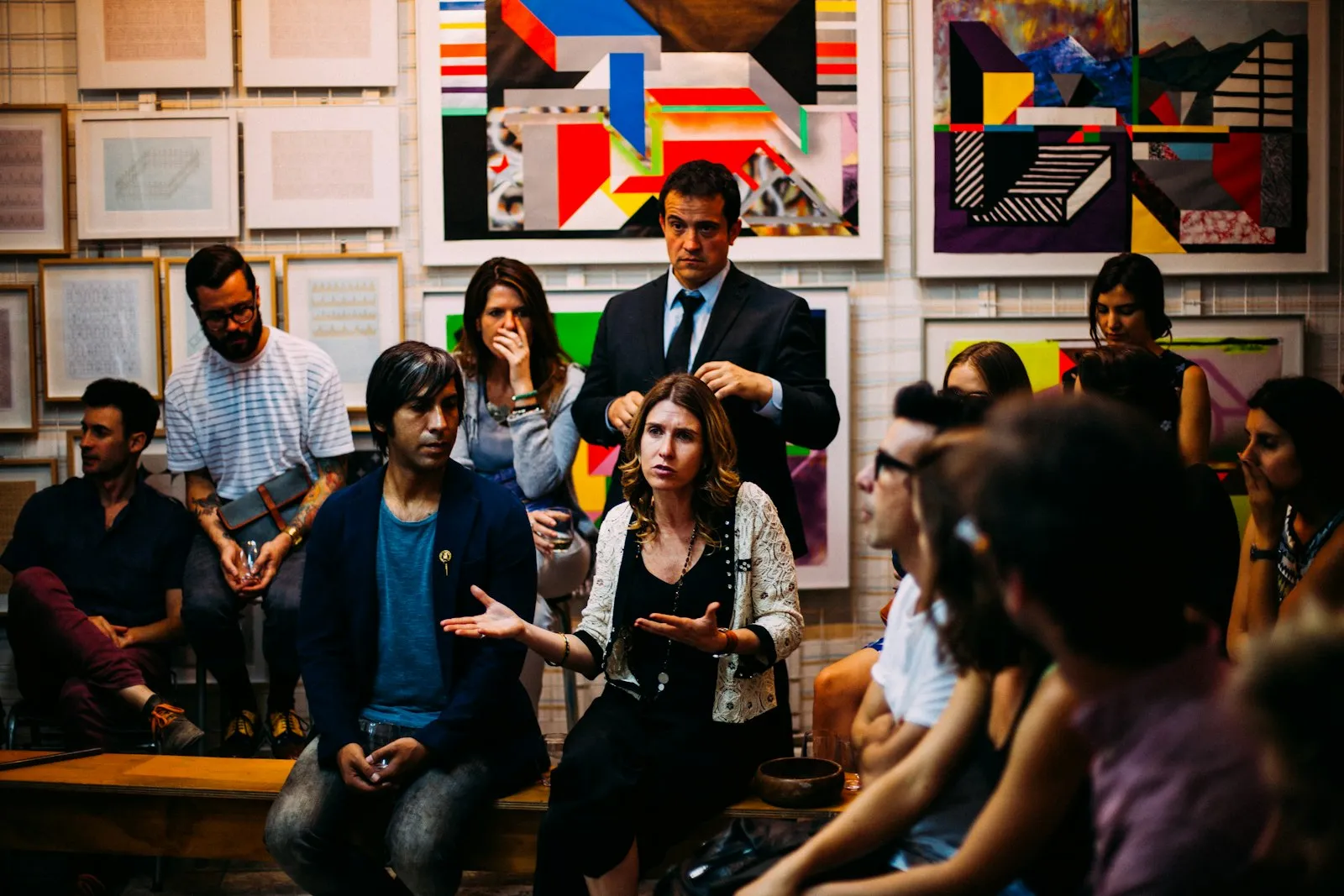 Exhibitors and attendees talking in a gallery-style exhibition space