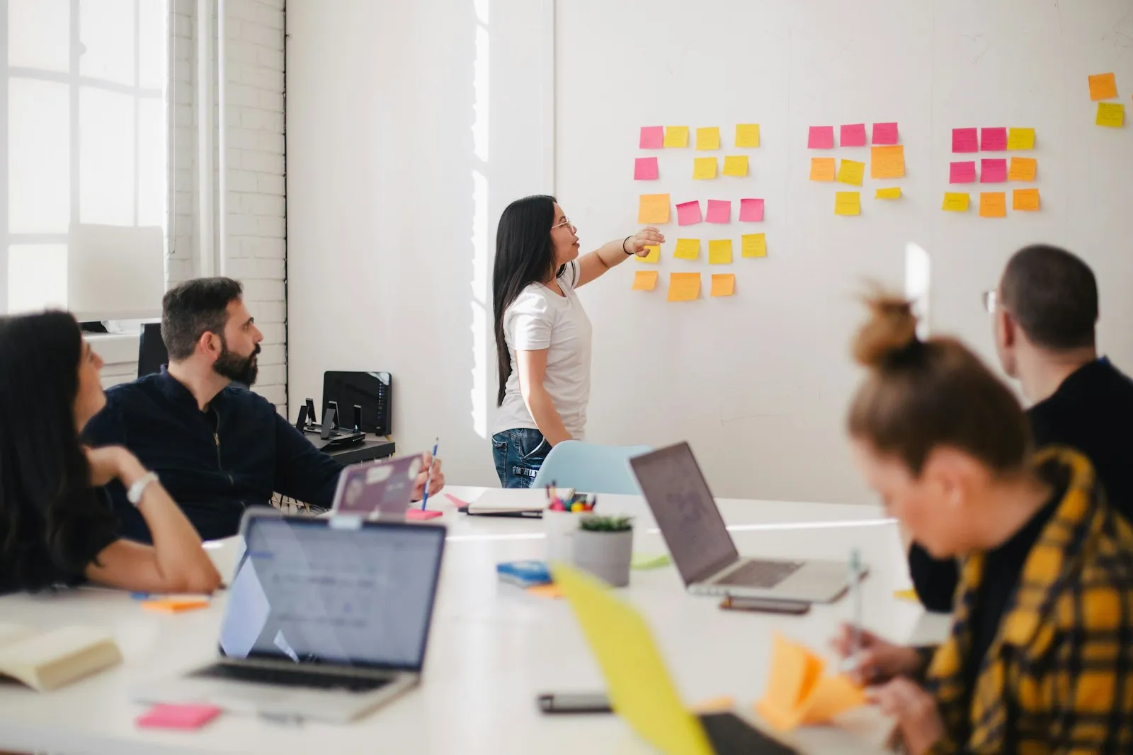 An event team mapping the stages of event planning with sticky notes on a board